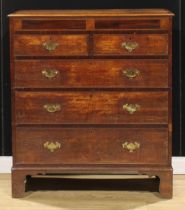 A George III oak and mahogany chest, of two short and three long graduated drawers, bracket feet,