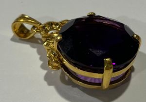 A gold coloured metal mounted Amethyst pendant, the large circular single stone facet cut, claw set,