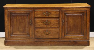 A 19th century oak low dresser, slightly oversailing top above three short drawers flanked by