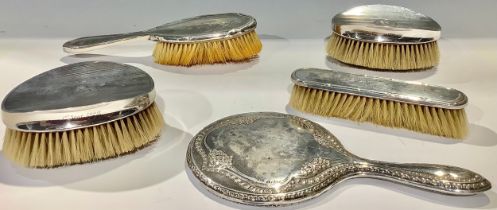 A pair of silver clothes brushes, Sheffield 1928; a silver vanity mirror, Birmingham 1916; silver