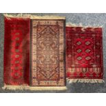 A Middle Eastern rectangular woollen rug or carpet, stylised geometric motifs, in tones of red and