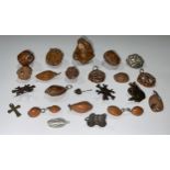 An interesting collection of Oriental pierced and carved nut kernel pendants and other jewellery;