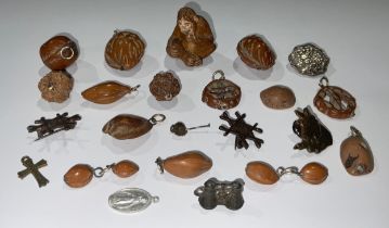 An interesting collection of Oriental pierced and carved nut kernel pendants and other jewellery;