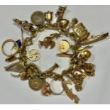 A 9ct gold curb link charm bracelet, assorted 9ct gold charms including, ape, cruise ship, horse and