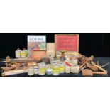 A collection of wooden weaving tools including shuttles, beaters, forks, bobbins, bodkins,