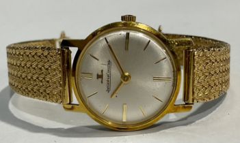 A lady's Jaeger Le Coultre gold plated watch, Champagne dial, baton indicators, marked "Plaque G