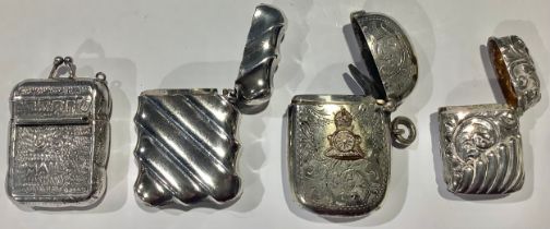 A Victorian silver vesta case, embossed with scrolls, stop fluted, 3.5cm, Birmingham 1892; a