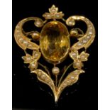 An Edwardian citrine and seed pearl brooch, stamped '9ct', the central large oval citrine 16mm high,