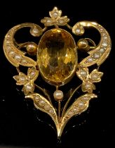 An Edwardian citrine and seed pearl brooch, stamped '9ct', the central large oval citrine 16mm high,