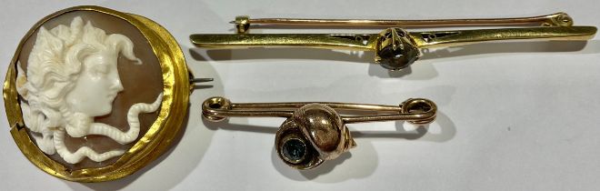 An Edwardian gold coloured metal bar brooch, probably 14ct, set with aquamarine, 4.1g; a 9ct gold