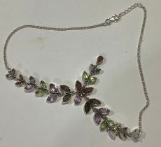 A silver and multi gemstone necklace, set with navette and pear shaped garnets, amethyst, and