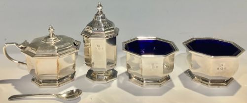 A silver four piece condiment set, comprising a pair of salts, pepper and mustard, blue glass