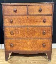 A George III oak and pine chest, of two short and three long graduated drawers, 112cm high, 92.5cm