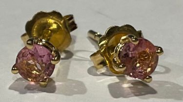 A pair of gold coloured metal ear studs set with brilliant cut pink stones, stamped '750' for 18ct