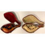 A Victorian meerschaum pipe, the bowl with two crossing horses, 12cm long; another similar 10.7cm