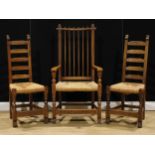 A harlequin trio of oak dining chairs, probably Rupert/Nigel Griffiths Monastic Woodcraft, one