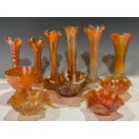 A Carnival amber glass trumpet vase, 28cm; five others smaller; a fluted rose pattern bowl; a