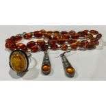 Amber - Victorian amber beads; silver and amber earrings; a silver and amber ring
