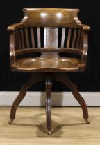 An early 20th century oak swivel desk chair, 83cm high, 59cm wide, the seat 49.5cm wide and 46cm
