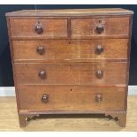 A George III oak chest, of two short and three long graduated drawers, 103.5cm high, 99.5cm wide,