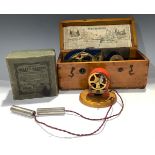 A late 19th/early 20th century hand-cranked electrotherapy device, cased; another, The New Health