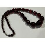 A graduated set of oval facet cut cherry amber beads