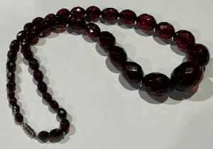 A graduated set of oval facet cut cherry amber beads