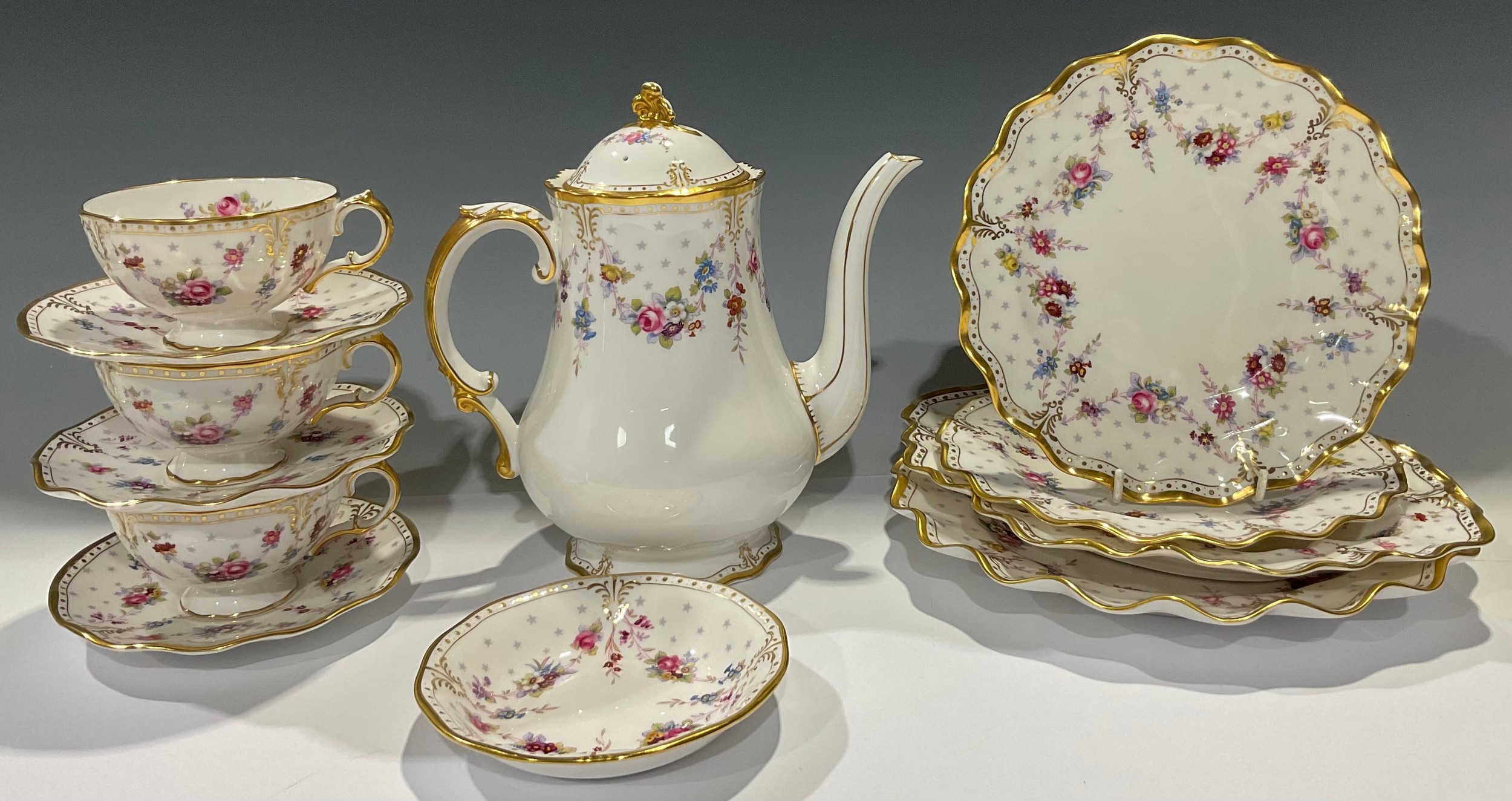 A Royal Crown Derby Royal Royal Antoinette pattern coffee pot, three teacups and saucers, pair of