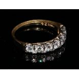 An 18ct gold ring, set with a row of seven brilliant cut diamonds, size M, marked 18ct, 3.1g