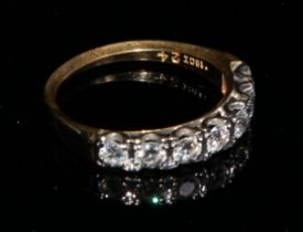 An 18ct gold ring, set with a row of seven brilliant cut diamonds, size M, marked 18ct, 3.1g