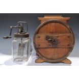 An early 20th century pine butter churn and cover, 40cm high; a glass butter churn (2)