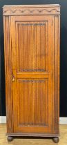 An oak hall cupboard or hanging press cabinet, linenfold panel door, 193.5cm high, 80.5cm wide, 40cm