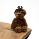 Toys & Juvenalia - a mid 20th century miniature jointed brown mohair teddy bear, pin eyes, wearing a