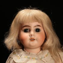 An Armand & Marseille (Germany) bisque head and ball jointed painted composition bodied doll, the