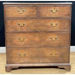 A George III oak chest, of two short and three long graduated drawers, skirted base, bracket feet,