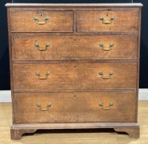 A George III oak chest, of two short and three long graduated drawers, skirted base, bracket feet,