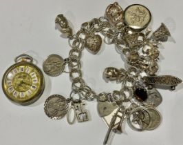 A silver charm bracelet, London 1979, various silver and other charms, 70.5g gross; a lady's fob