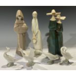 A Lladro figure, girl with basket, 33cm, printed mark; others, pair of nuns; friar; four Lladro