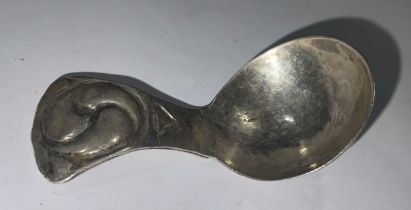 An Arts and Crafts white metal caddy spoon, probably silver, 7cm long