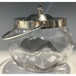A George V silver and clear glass biscuit barrel, swing handled, domed cover with spire finial, 19cm