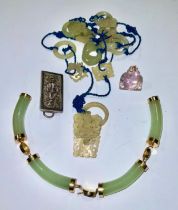 A Chinese jade pendant; a hardstone Buddha fob; a bangle (a/f); a silver brooch