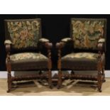 A pair of late Victorian oak Baronial type armchairs, 100cm high, 68cm wide, the seat 53cm wide
