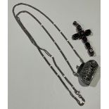 A silver cross pendant set with seven oval cut garnets divided by marcasites; a silver coin pouch (