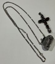 A silver cross pendant set with seven oval cut garnets divided by marcasites; a silver coin pouch (