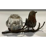 A 19th century cold painted bronze inkstand, modelled as a robin perched on a branch, clear glass