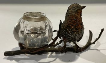A 19th century cold painted bronze inkstand, modelled as a robin perched on a branch, clear glass