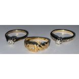 A 14ct gold diamond solitaire ring, illusion set, each shoulder accented with diamond chips, size