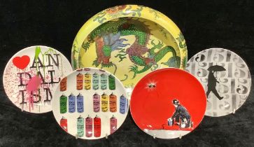 A Burslem ware dragon lustre bowl; a set of four Royal Doulton plates