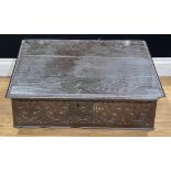 An 18th century oak desk box, the front carved with leafy motifs, 29.5cm high, 67.5cm wide, 42.5cm