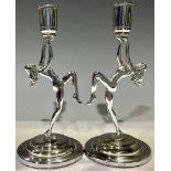 A pair of Art Deco chrome figural candlesticks, each as a female nude dancer, 18.5cm high